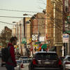 a student walks down a busy street in North Philadelphia