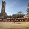 A student walks past Temple's motto on Main Campus.