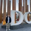 Student standing in front of sign at Dublin City University in Dublin, Ireland.