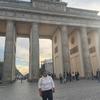 Pomales stands in front of Brandenburg Gate at golden hour